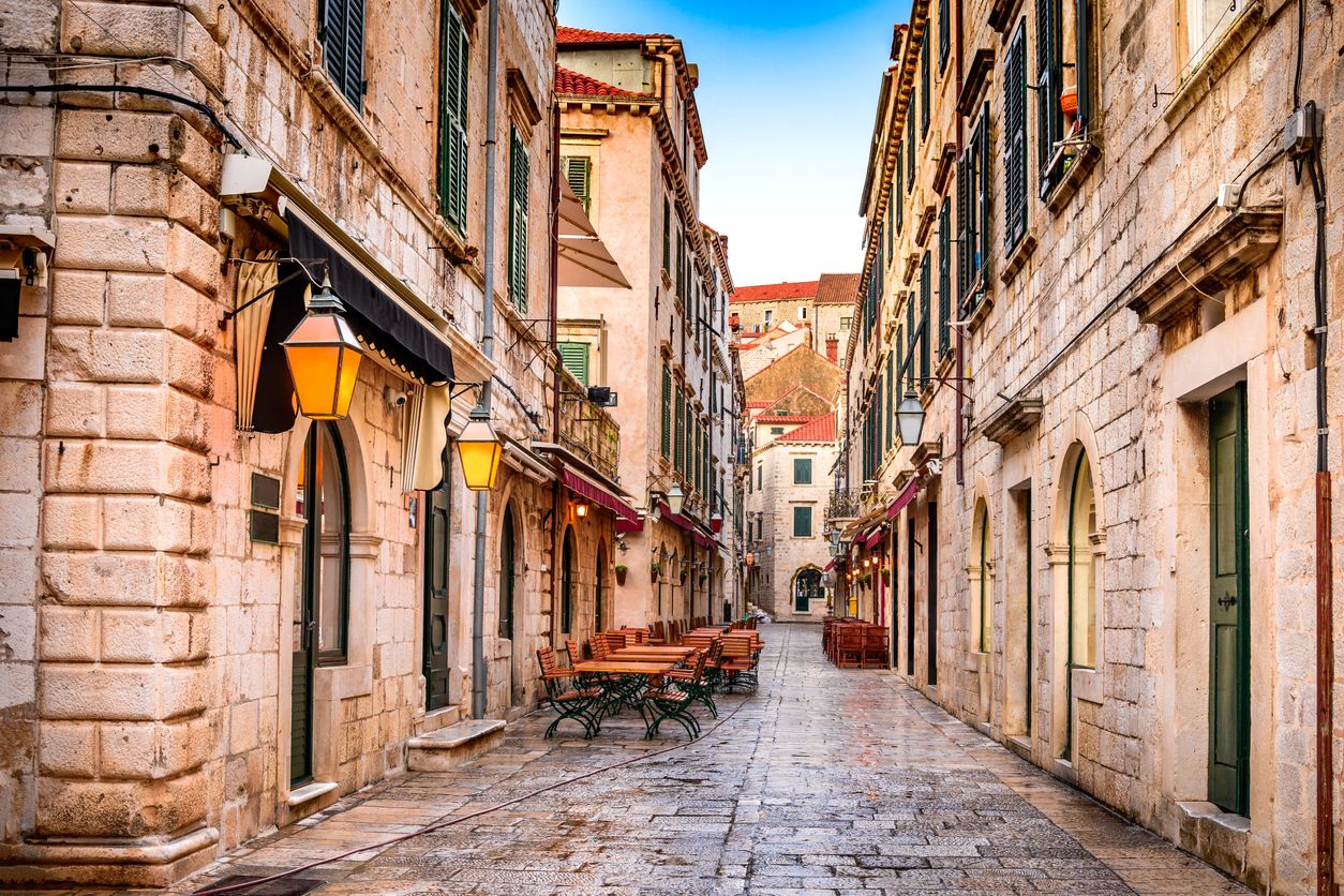 Old town of Dubrovnik with cobbled streets and benches.