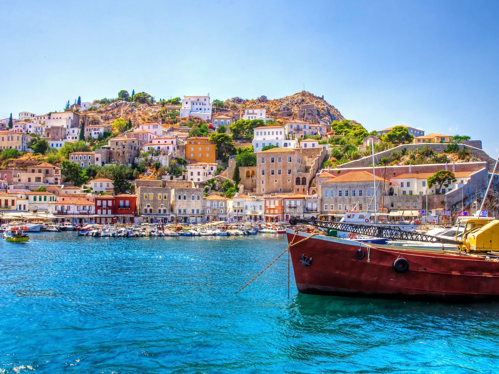 There is a fishing boat on the foreground and some local architecture on the background