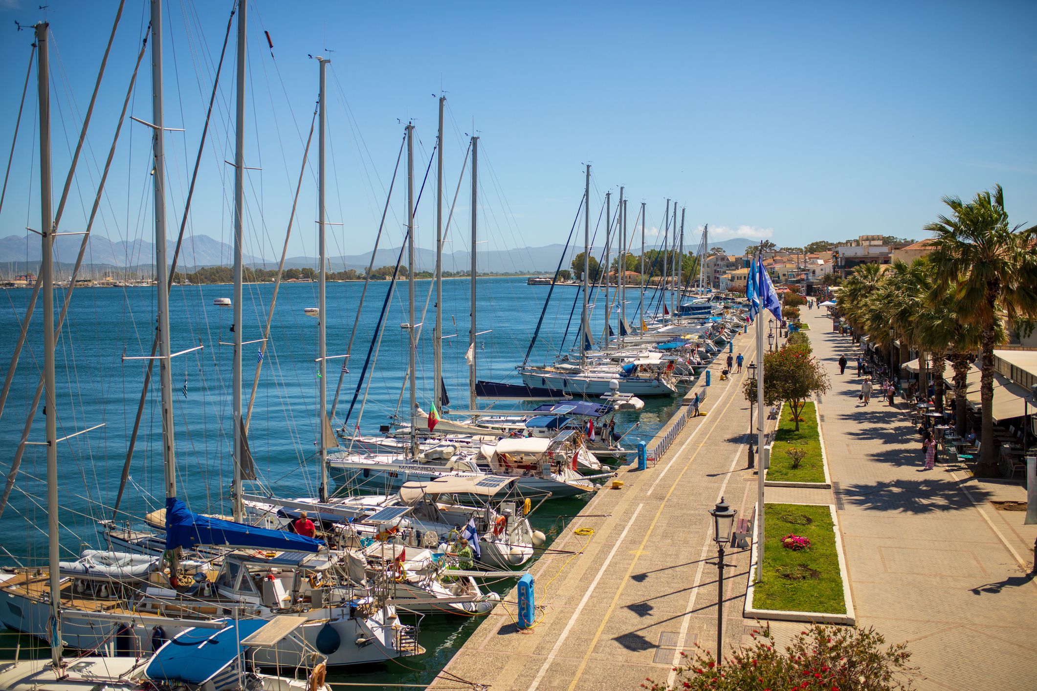 Day life in beautiful town Preveza located on Ionian sea coast. Nice bay with calm water, very long yacht and sailboat marina, sidewalk with park and nice modern architecture makes this place recognizable