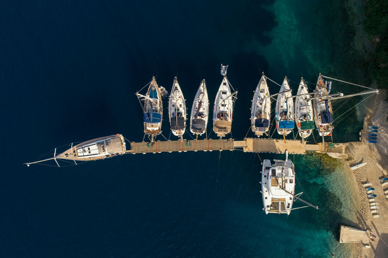 Sailboats and yachts in small port Near village Spartachori on Meganisi island, Greece
