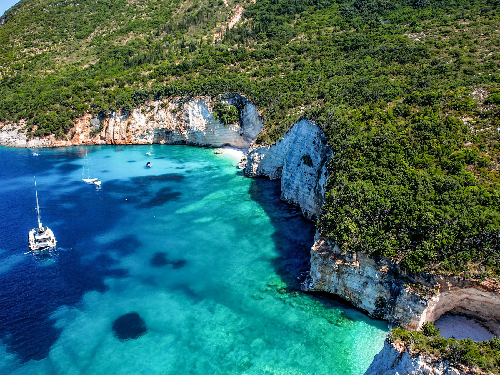 Fteri Beach on the island of Kefalonia, Greece. A beautiful pebble beach on the clear emerald blue Ionian Sea.