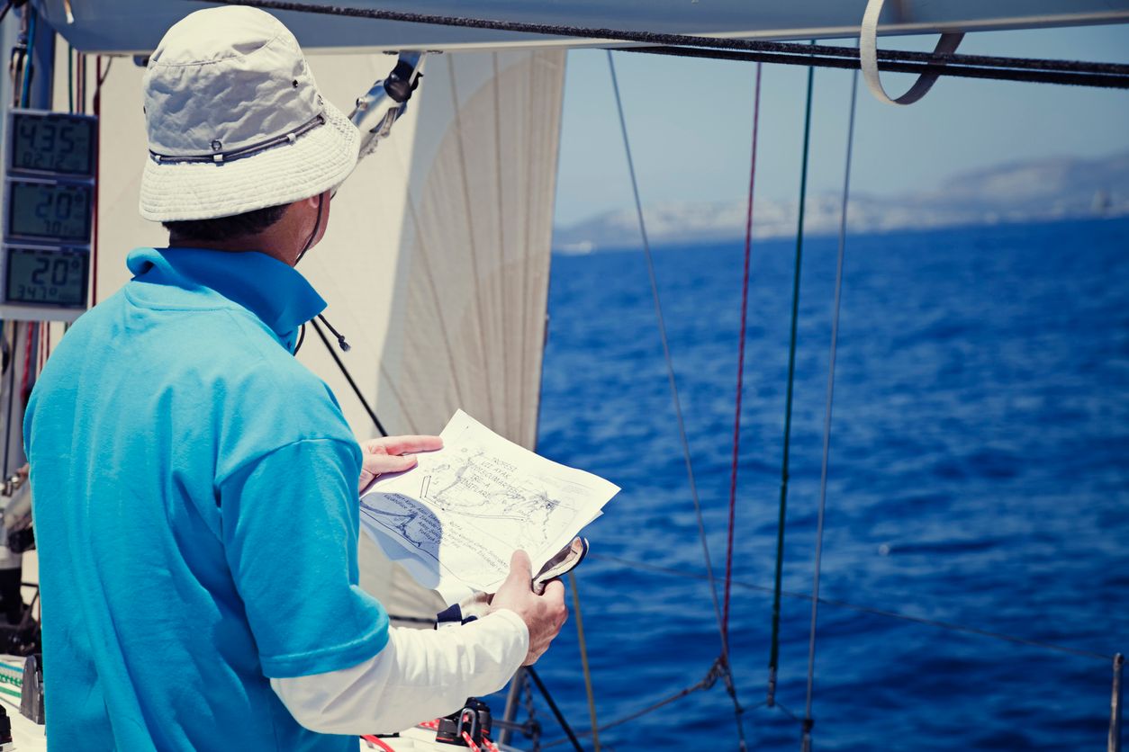 Sailing crew member checking map