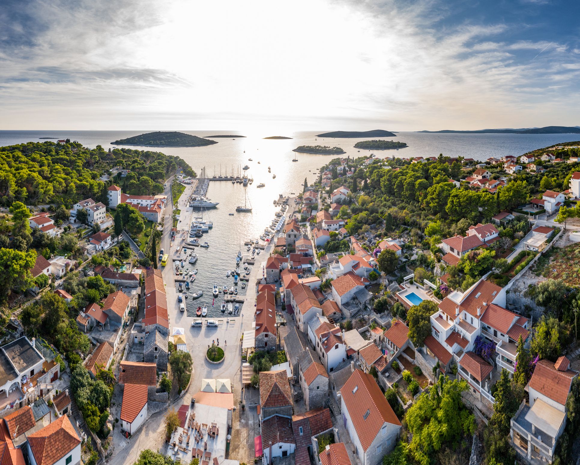 Aerial view of the Maslinica marina, houses with orange roofs and anchored ships