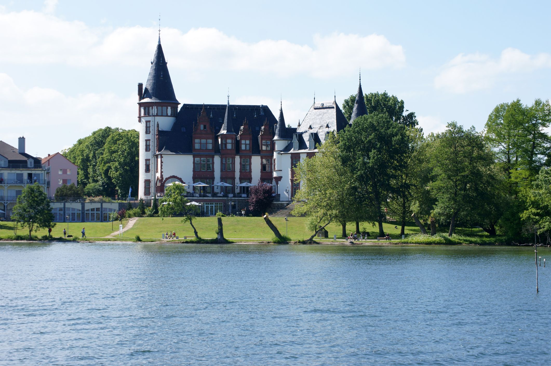Vacationers and tourists walk along the boardwalk at the castle Klink on June 09, 2013 in Waren.