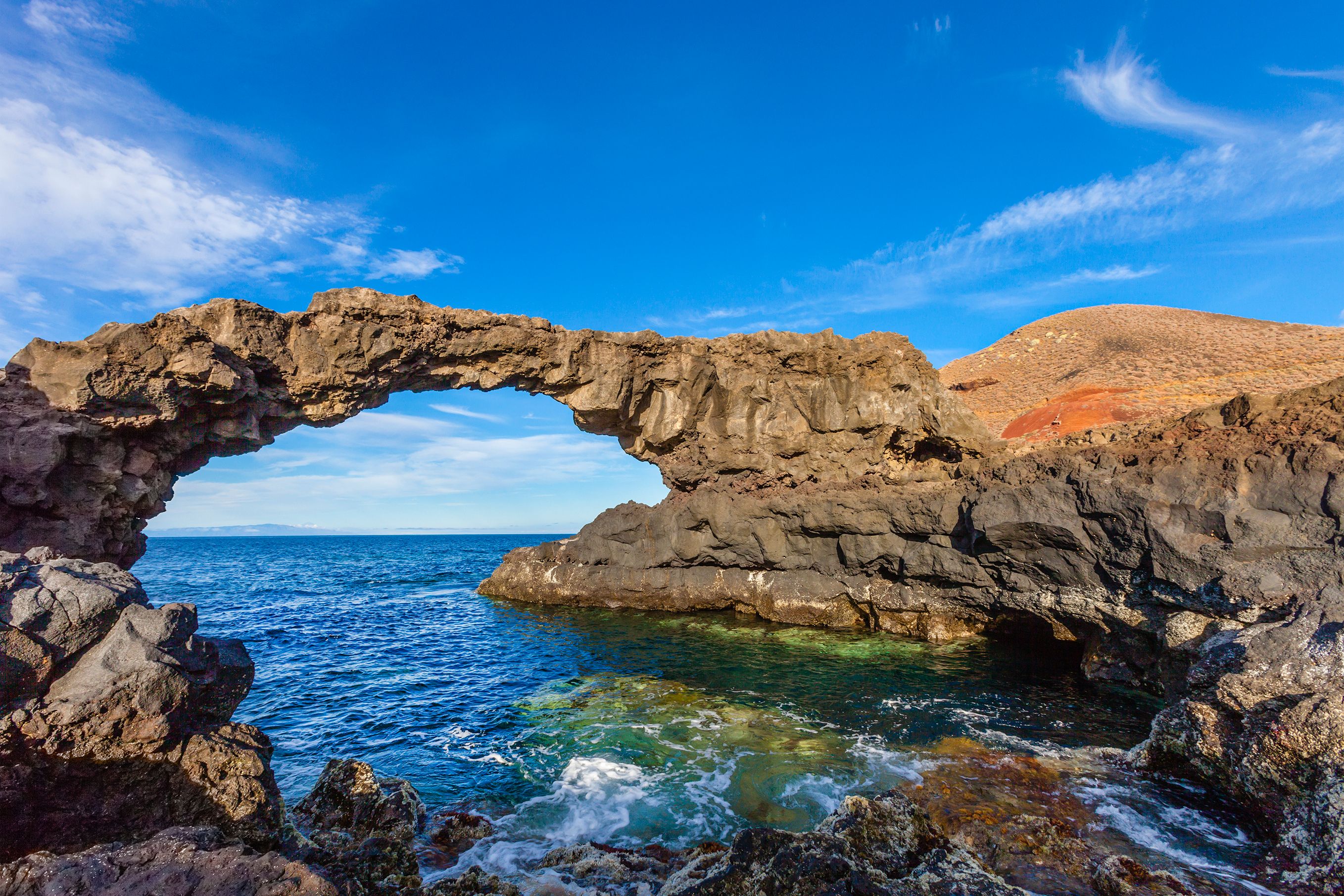 Arch of volcanic rock known as Charco Manso; nearby you can find a fantastic bathing place. Echedo, El Hierro, Canary Islands