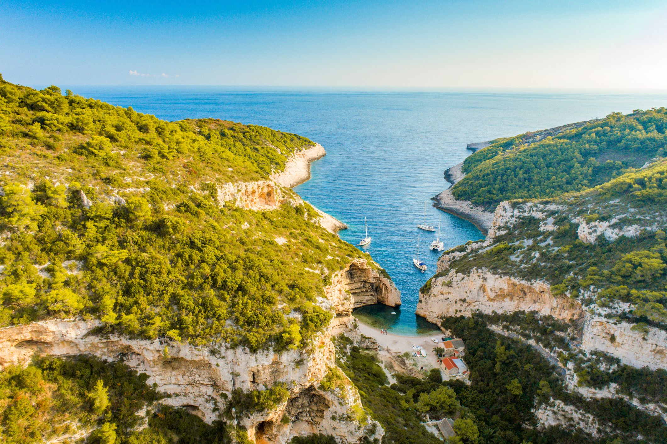 Cliff with boats and Stiniva beach